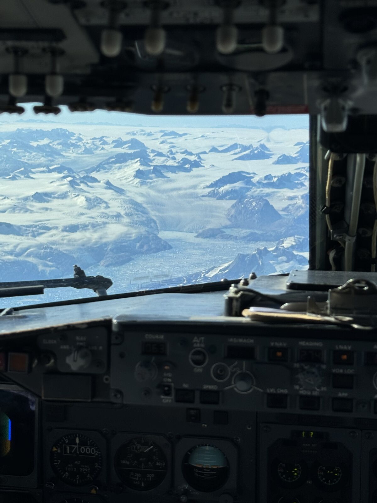 Cockpit panel with glaciated mountains ahead