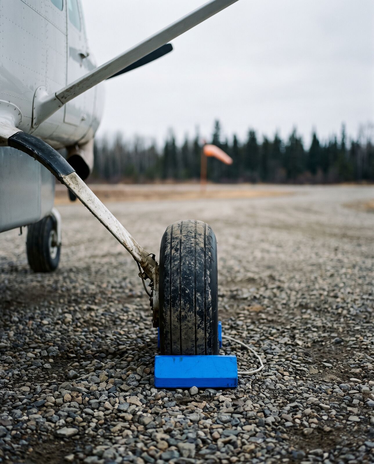 Main gear and chock on a gravel strip