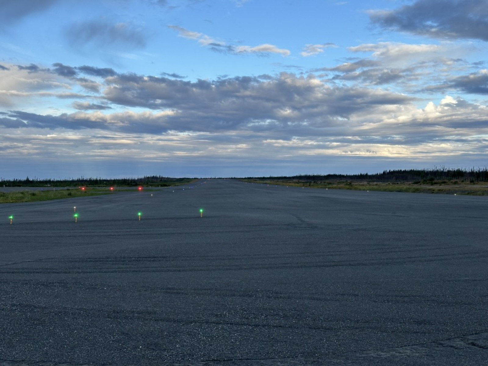 A remote runway at dusk with edge lights lit
